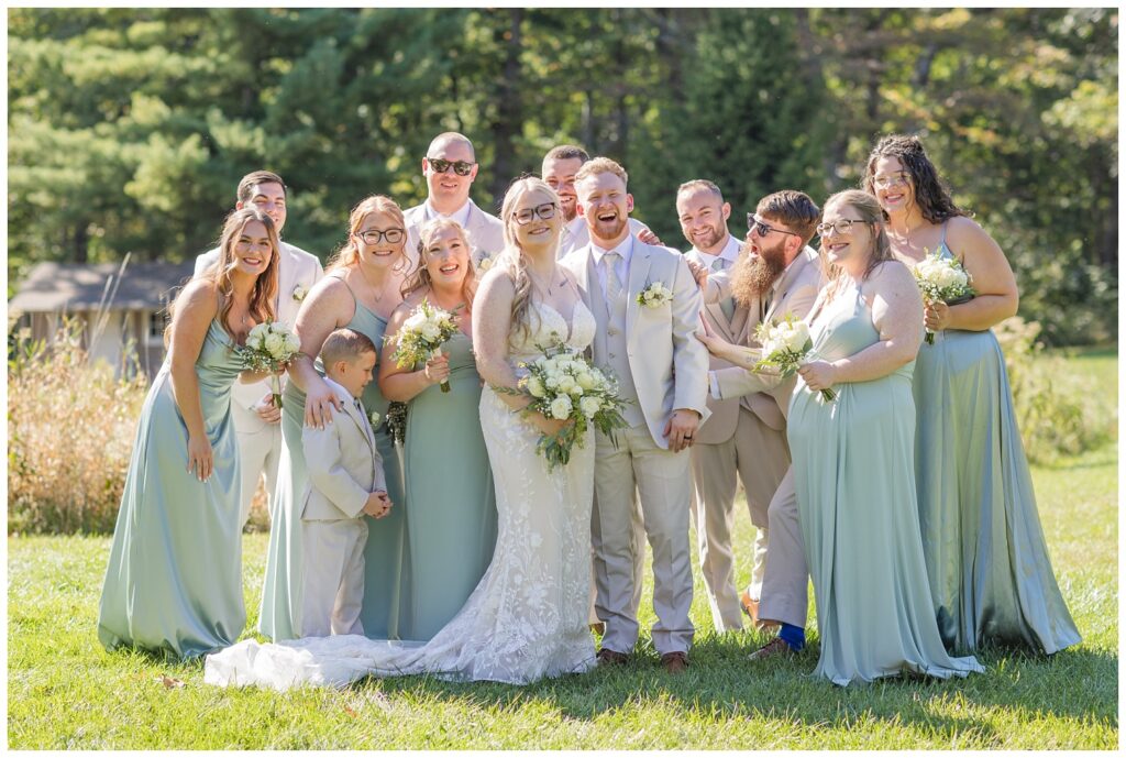 full wedding party posing and laughing at Bradner Preserve 