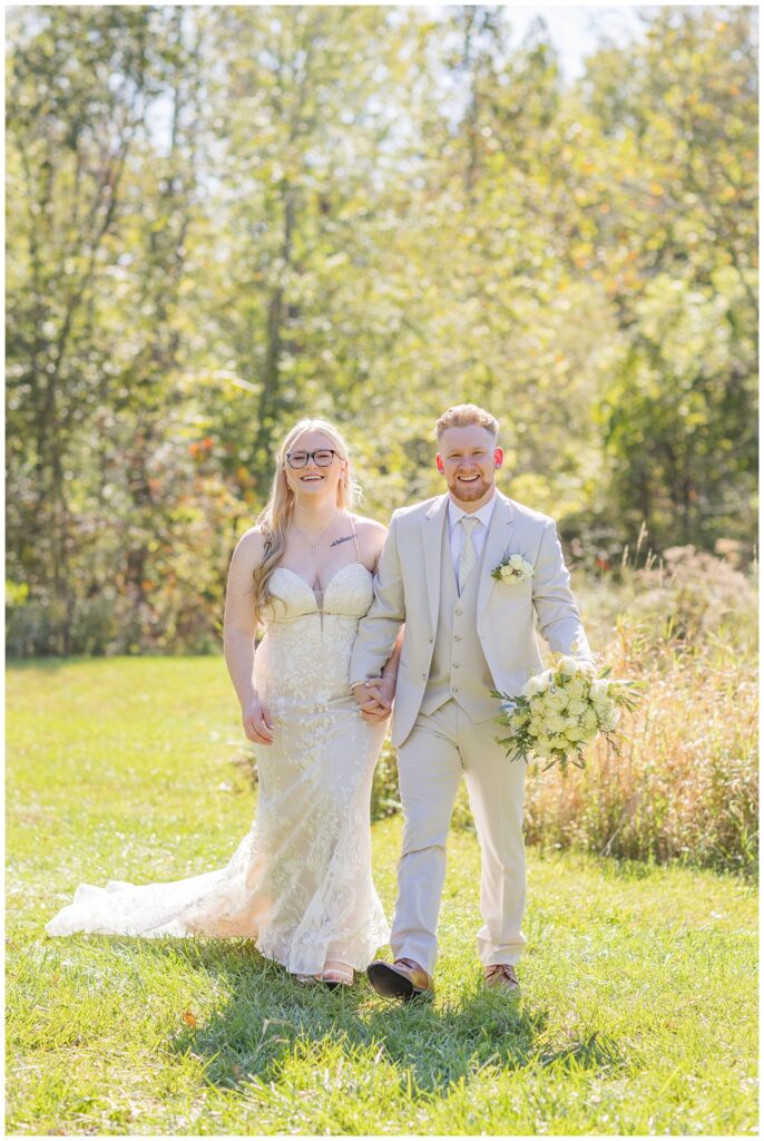 bride and groom holding hands together at Bradner Preserve in Bowling Green, Ohio