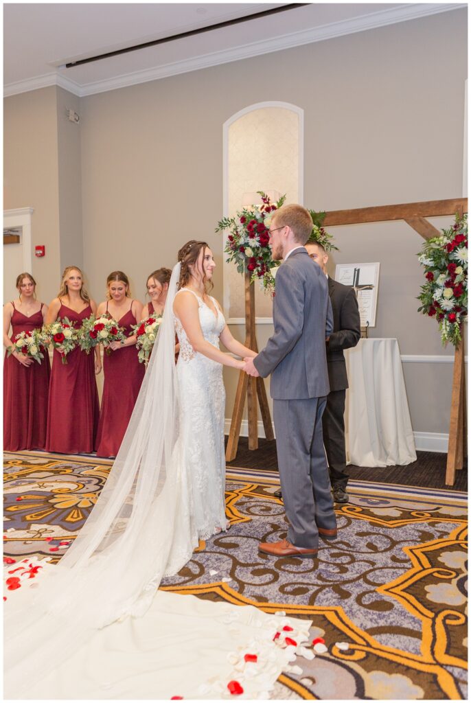 bride and groom saying their vows at the altar at fall hotel wedding