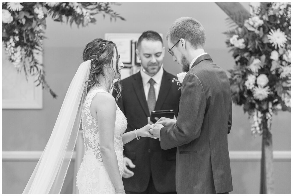 wedding couple exchanging rings at the altar at fall hotel wedding 