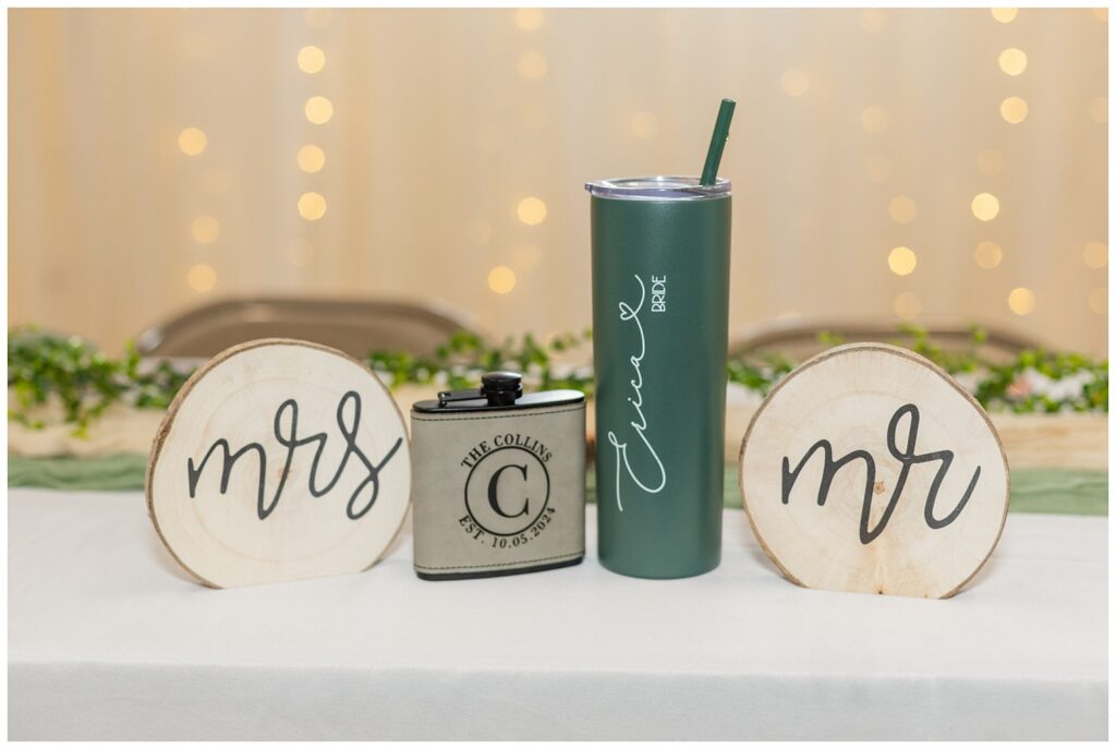 flask and tall cup for the bride and groom sitting at the reception table 