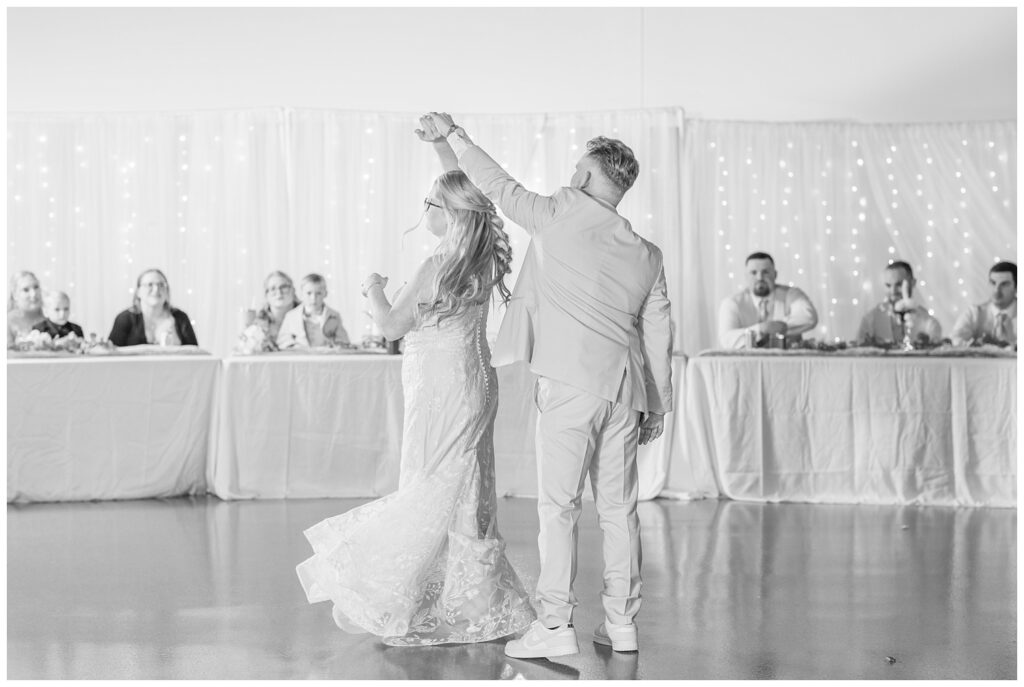 groom twirling the bride during their first dance in Fostoria, Ohio