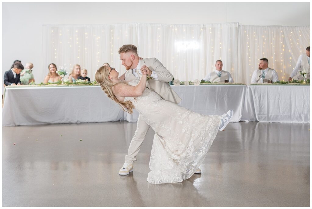 groom and bride wearing matching shoes for the reception dancing 