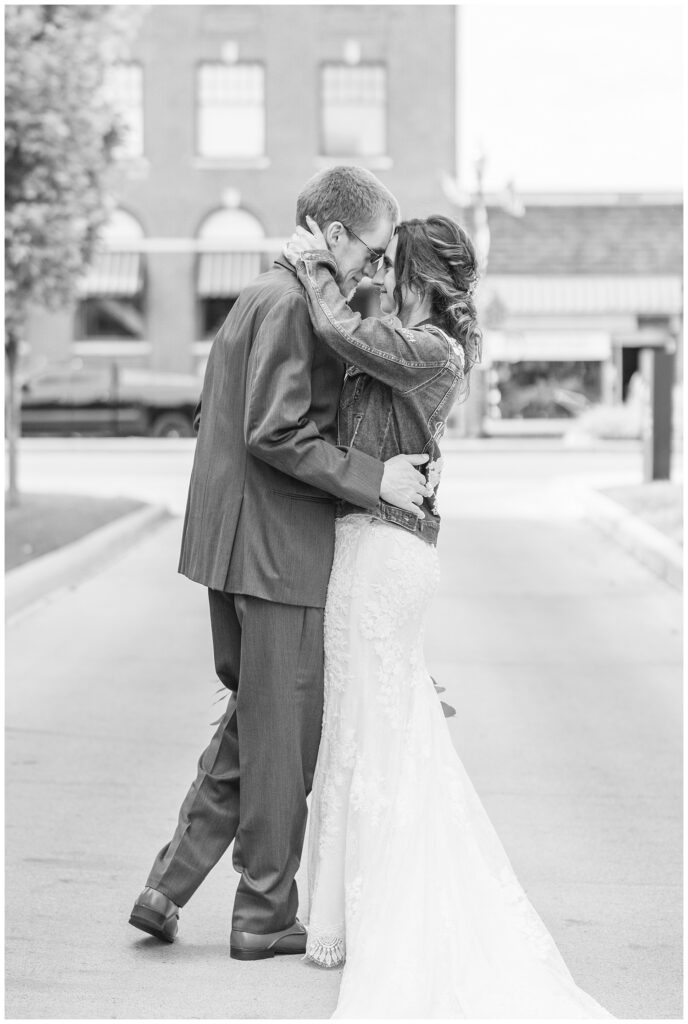 bride and groom touching foreheads while posing in downtown Findlay, Ohio