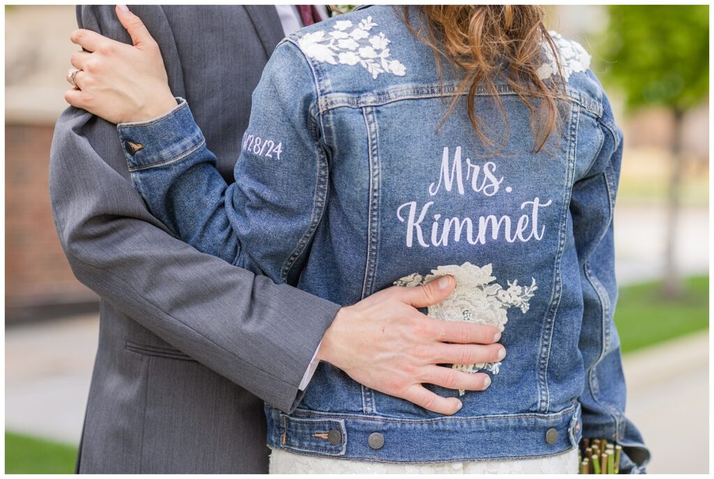 the back of the bride's custom made jean jacket with her new last name