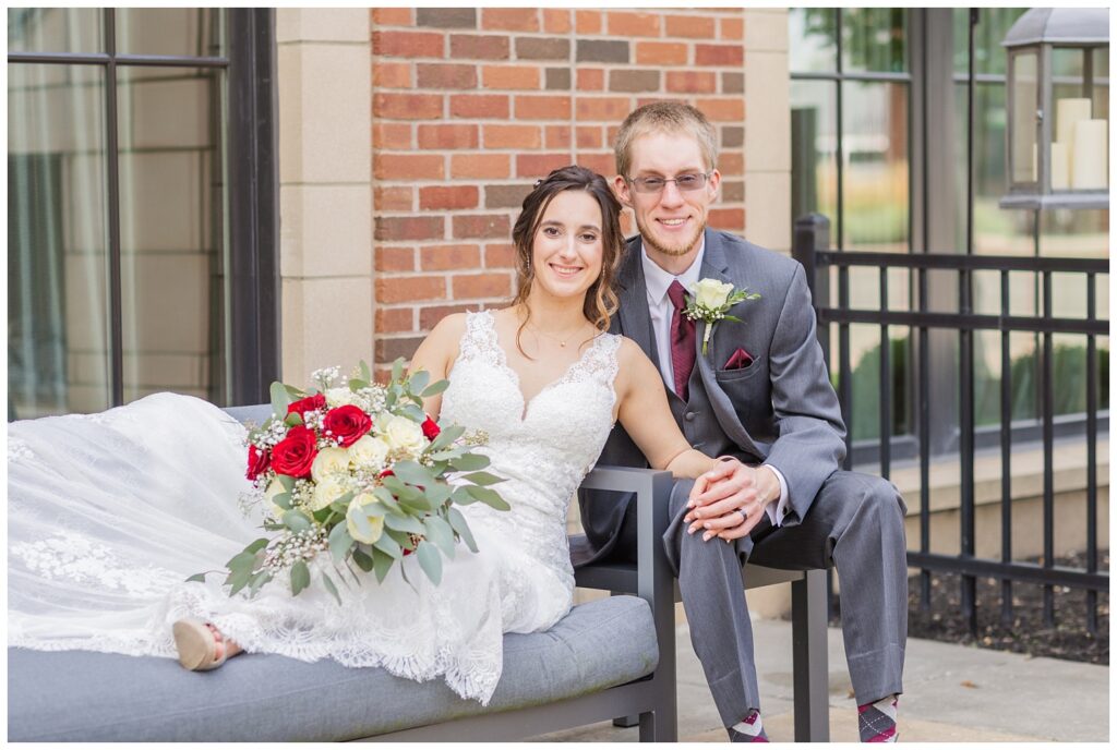 bride and groom posing outside on the patio at The Hancock Hotel in Findlay, Ohio