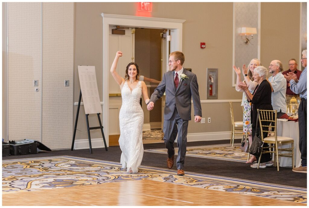 wedding couple making their entrance into the banquet hall reception 