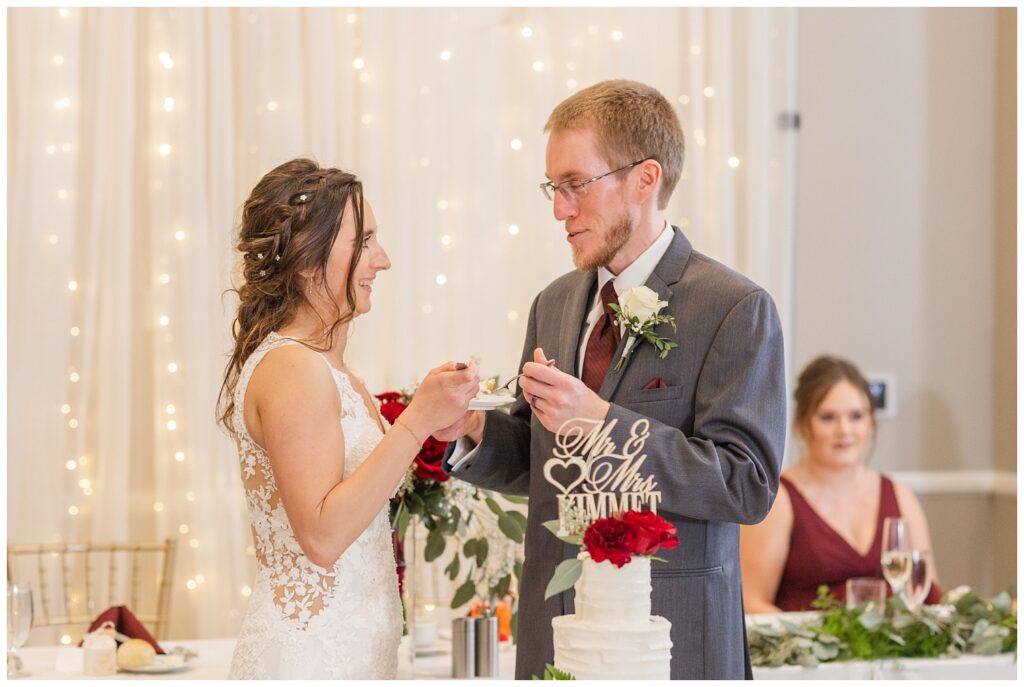 wedding couple cutting the cake at The Hancock Hotel reception