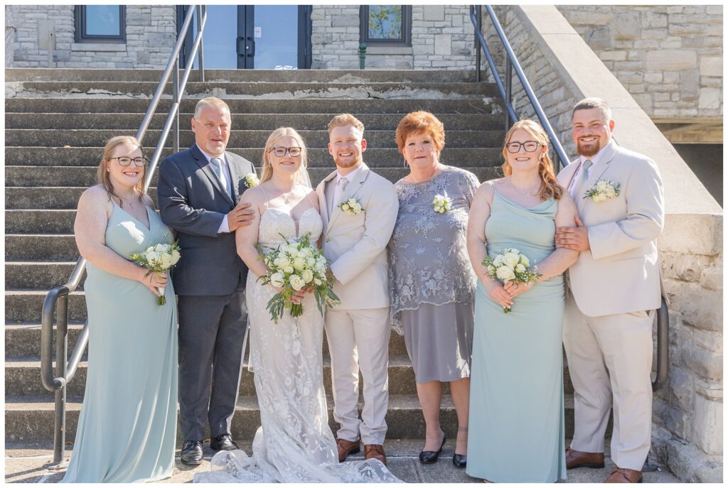 family wedding portraits in front of the stairs at Thompson Stone Hall