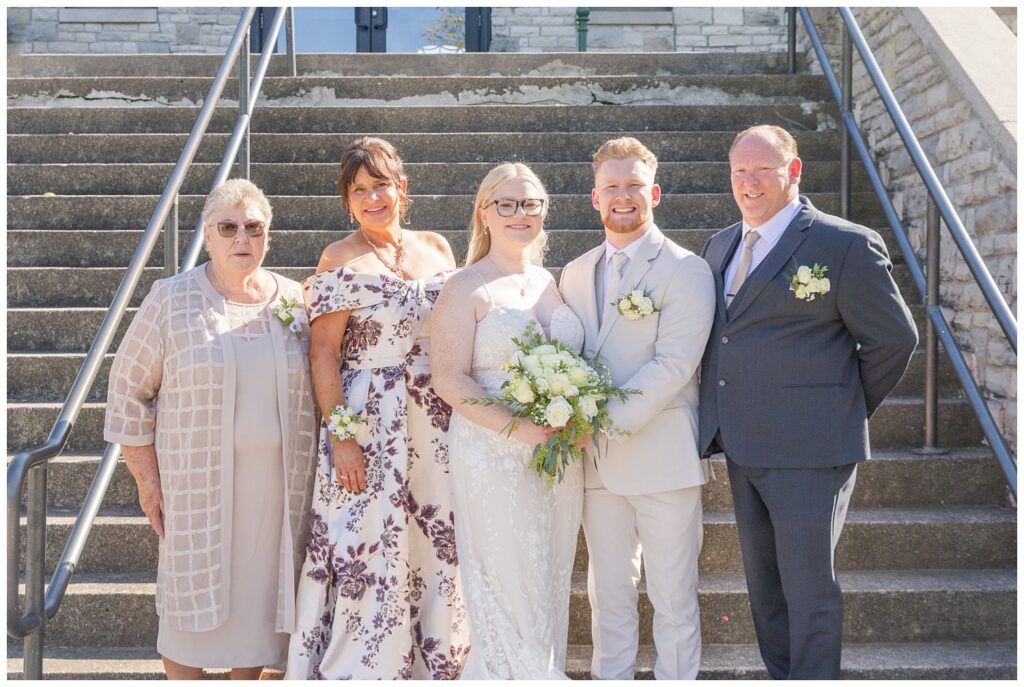 family wedding portraits in front of the stairs at Thompson Stone Hall