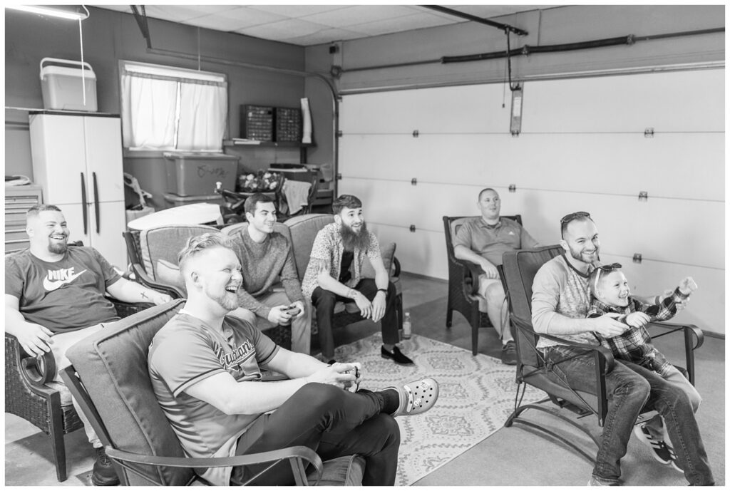 groomsmen watching tv and getting ready for the wedding in the garage