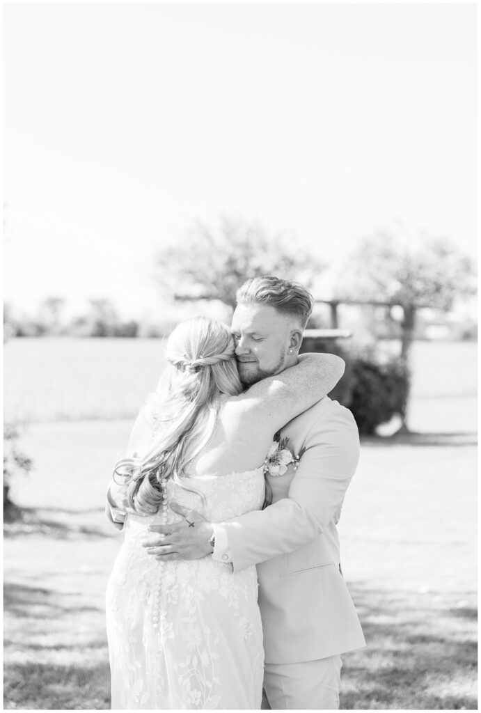 bride and groom hugging during first look in a backyard in Bowling Green, Ohio