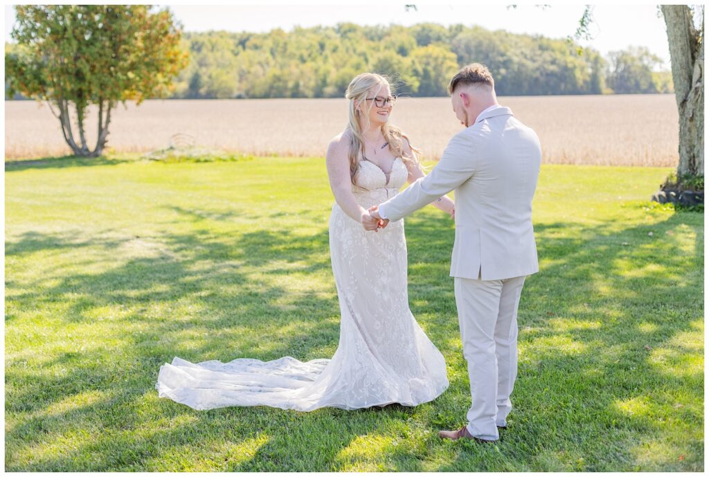 first look between the bride and groom outside in the grandma's backyard 