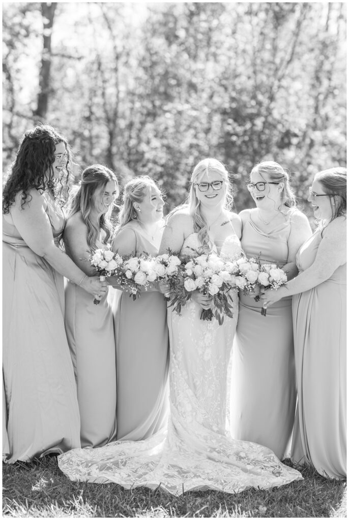 bridesmaids posing and laughing next to tall grass at Bradner Preserve