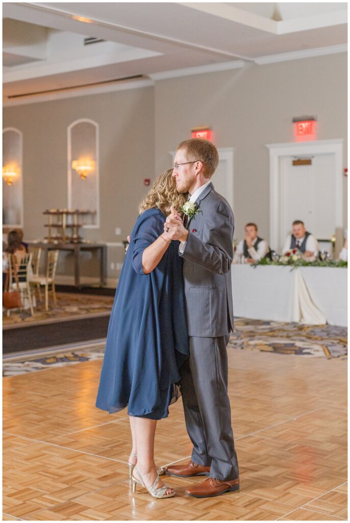 groom dancing with his mom at fall wedding reception at The Hancock Hotel