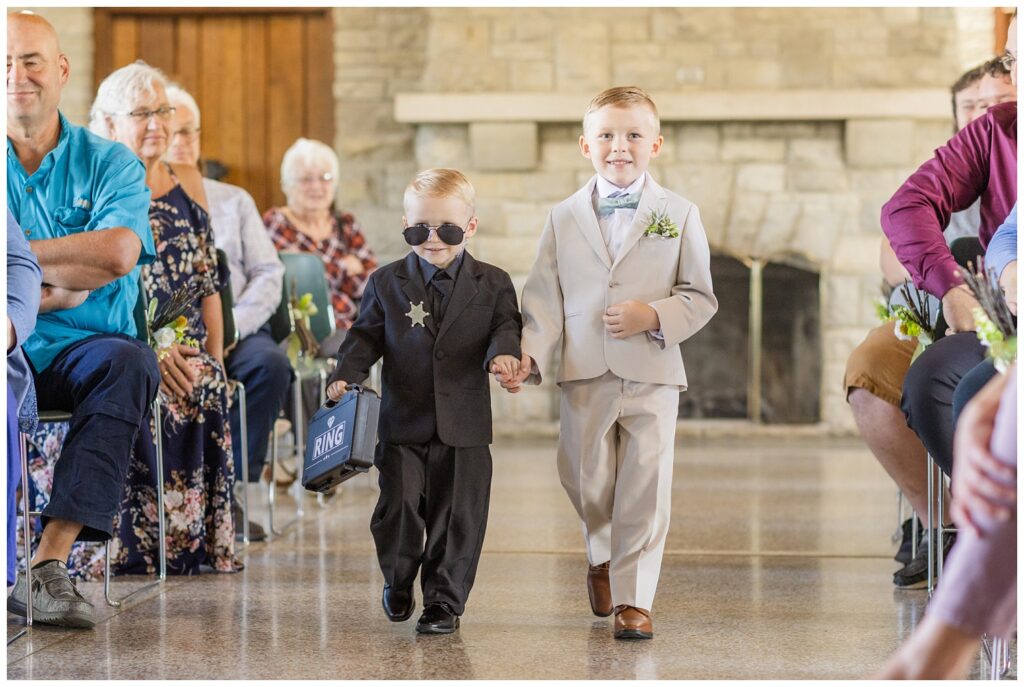 ring bearer and junior groomsman walking down the aisle at Thompson Stone Hall