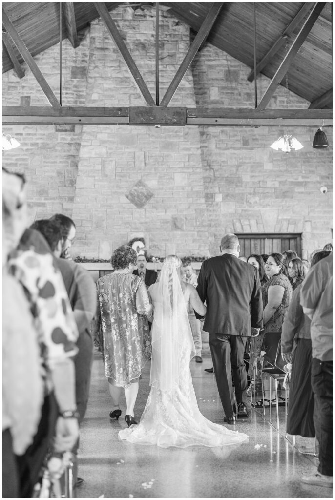 bride walking down the aisle with her parents at Thompson Stone Hall ceremony