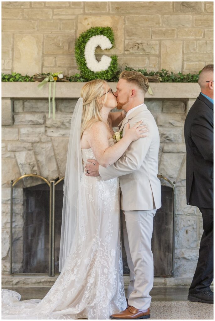 bride and groom share kiss at the end of the wedding ceremony in Otsego Park