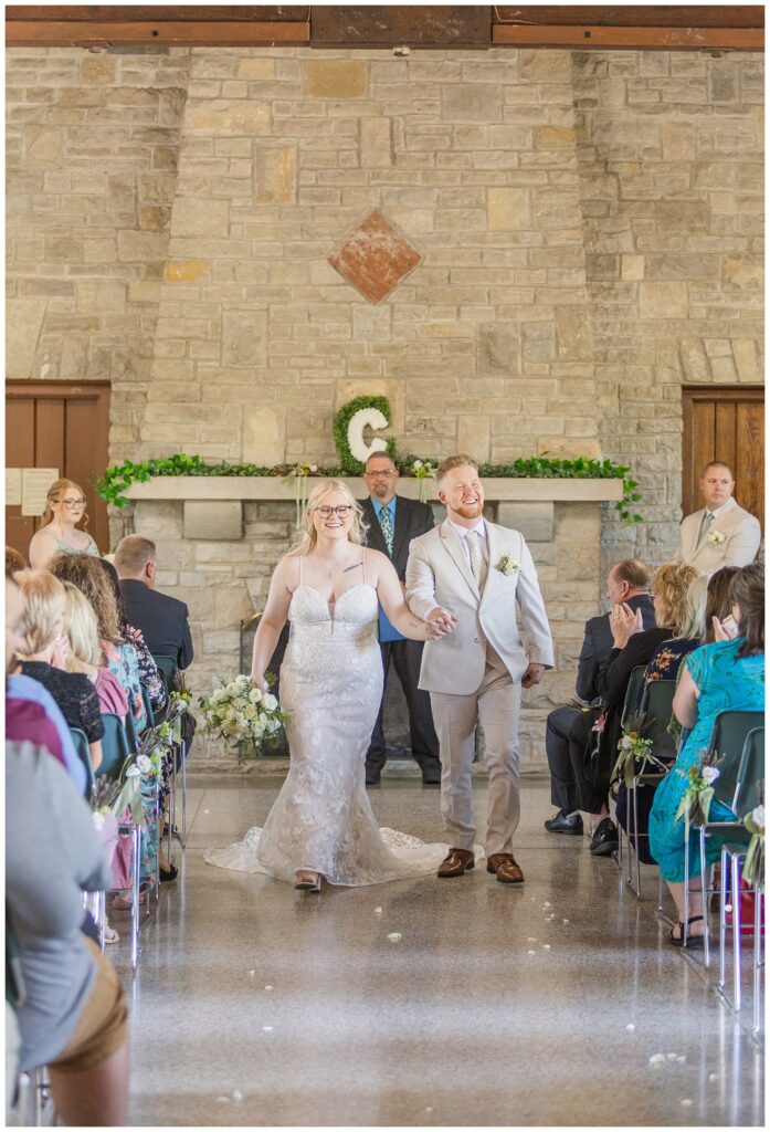 bride and groom share kiss at the end of the wedding ceremony in Otsego Park