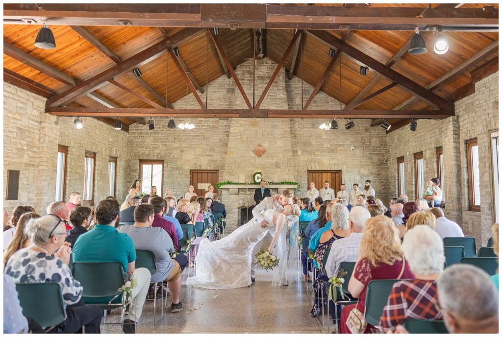 groom dipping the bride back for a dip and kiss at Thompson Stone Hall ceremony