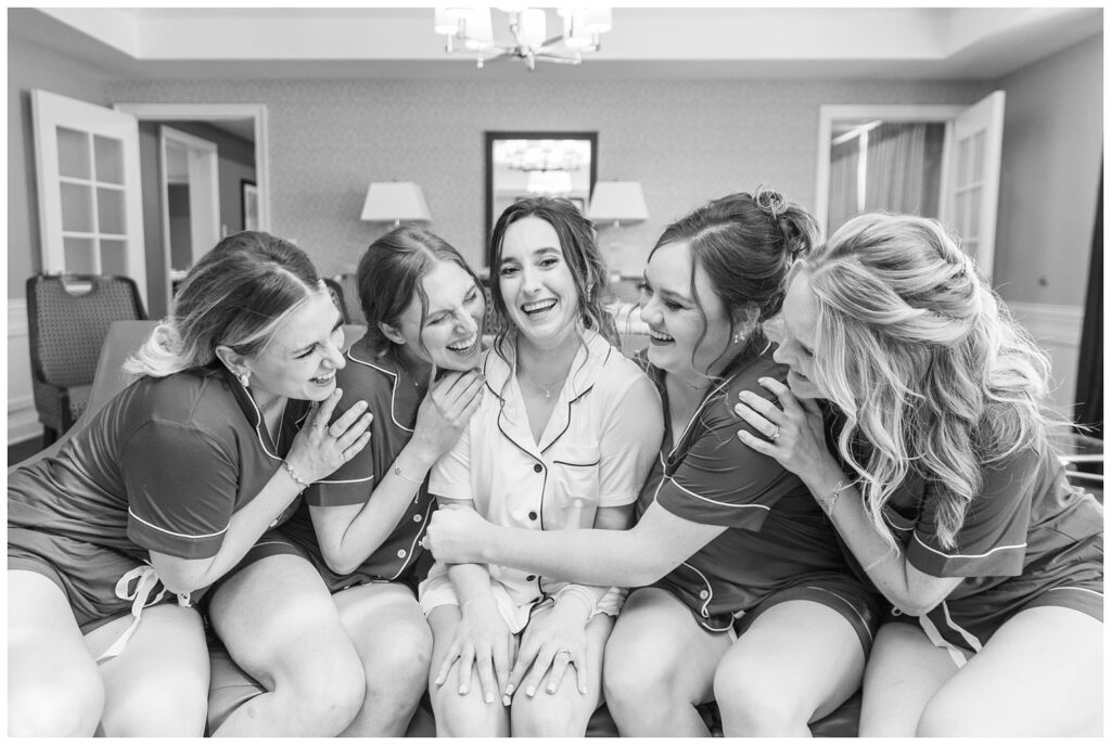 bride and bridesmaids wearing matching pajamas while getting ready