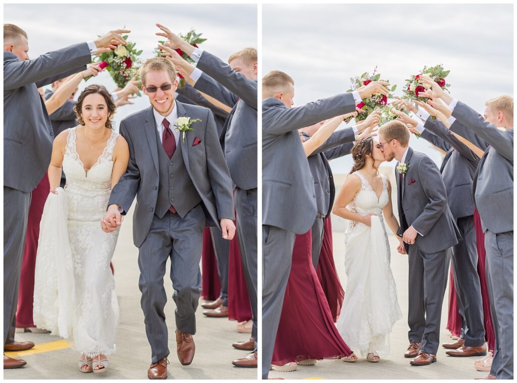 bridal party making a tunnel while the wedding couple goes under on the parking garage