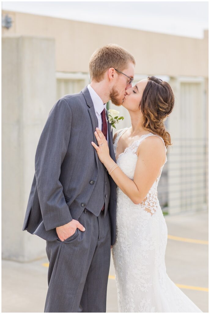 wedding couple sharing a kiss on top of the parking garage in northwest Ohio