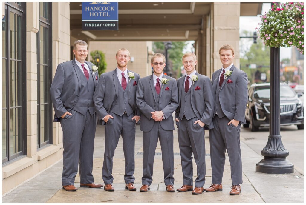 groomsmen walking together at the front entrance of the hotel in Findlay, Ohio