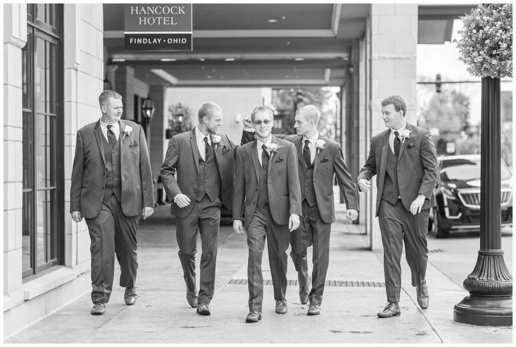 groomsmen walking together at the front entrance of the hotel in Findlay, Ohio