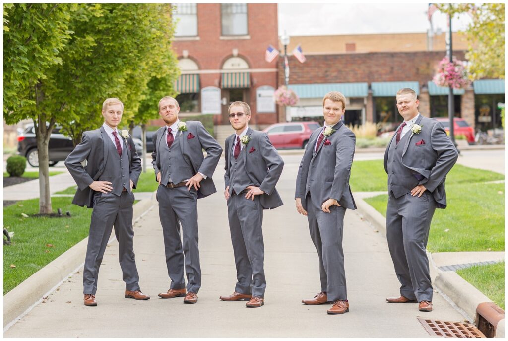 groomsmen doing a funny pose in downtown Findlay, Ohio