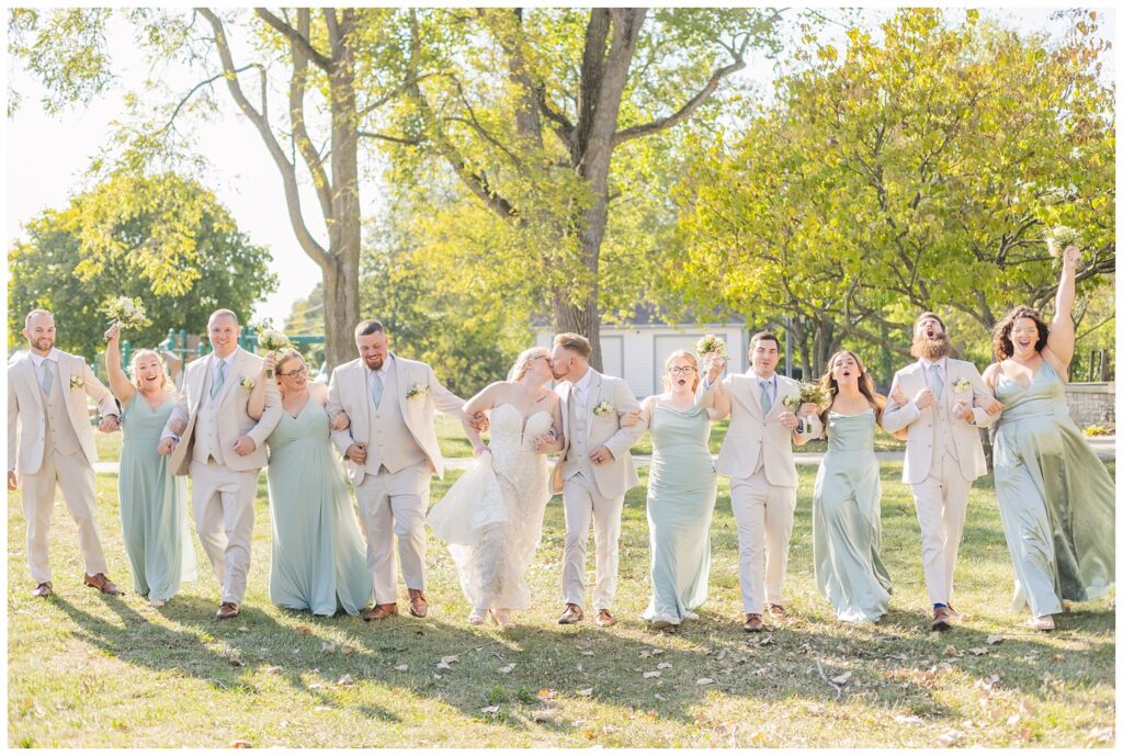 full wedding party walking together outside at Thompson Stone Hall in Ohio