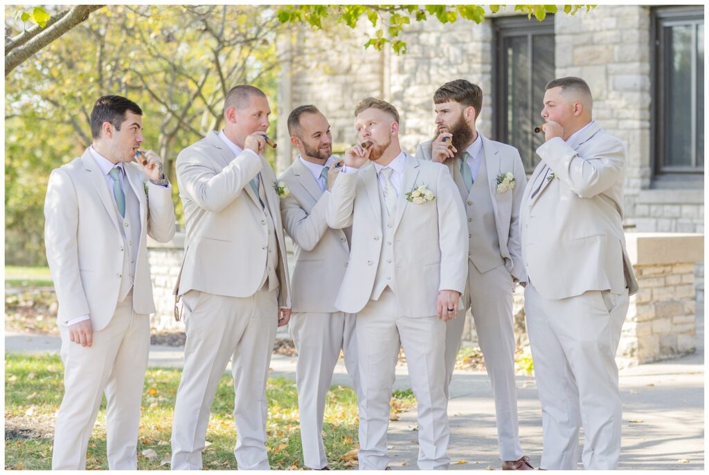 groomsmen smoking cigars near the entrance of Thompson Stone Hall in Bowling Green, Ohio