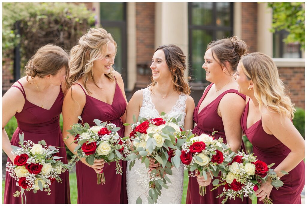 bride laughing with her bridesmaids outside at the hotel in northwest Ohio