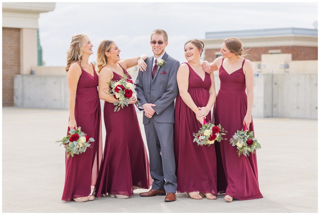 groom posing with the bridesmaids at The Hancock Hotel