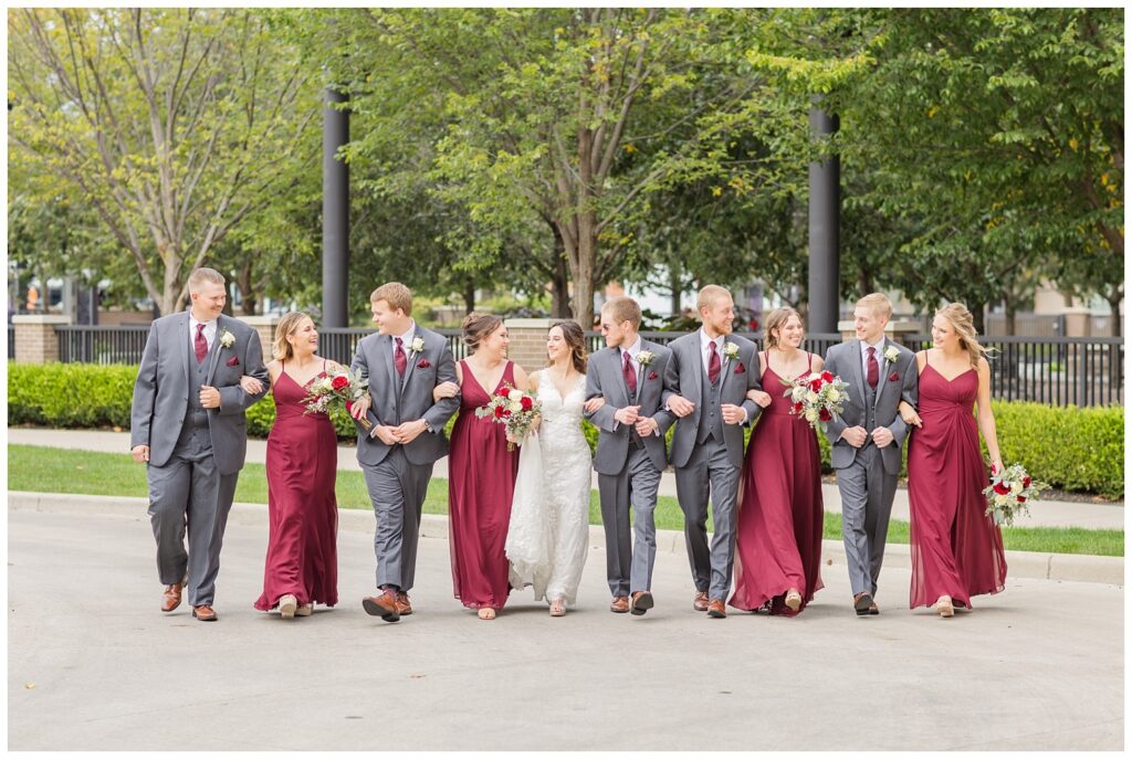 wedding party all walking arm in arm near The Hancock Hotel