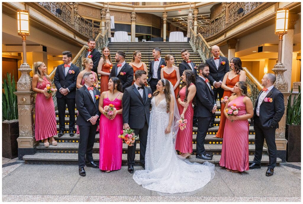 full wedding party posing on the stairs laughing and smiling in Cleveland