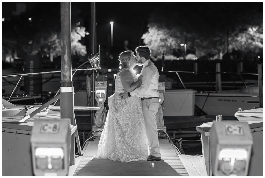 wedding couple posing on the gangway at night at Sandusky Yacht Club