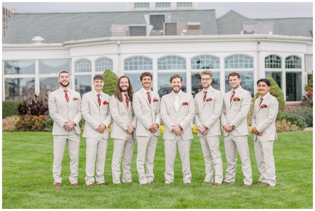 groomsmen posing in a straight line outside at the Sandusky Yacht Club