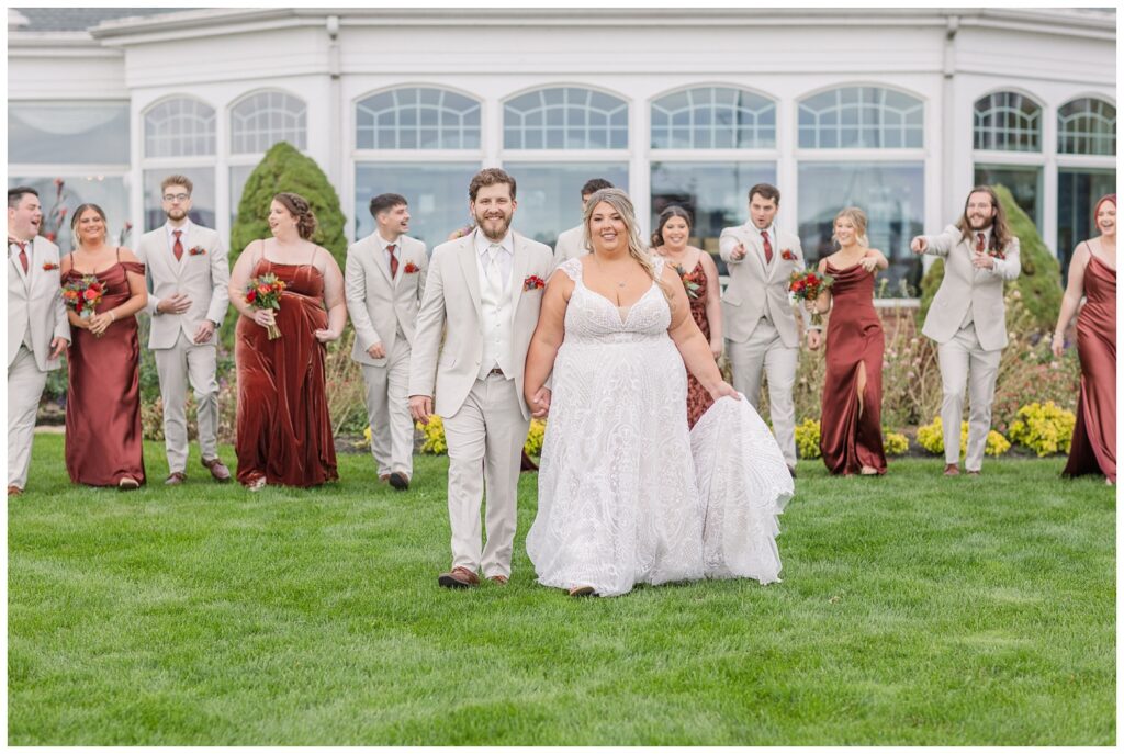 bride and groom walking ahead of the wedding party at the yacht club in Sandusky