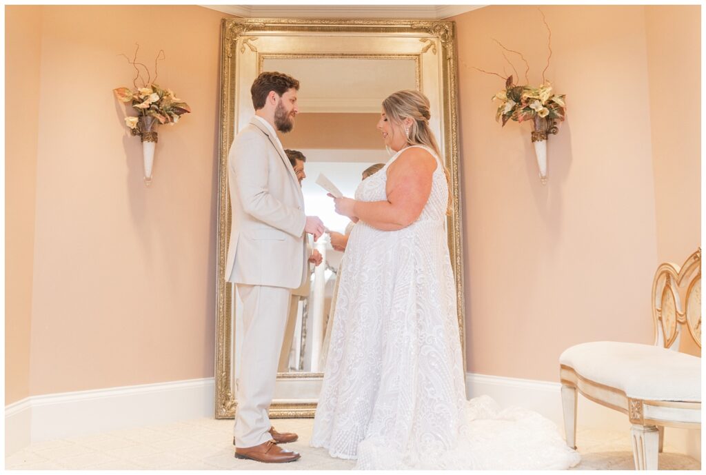 bride and groom read aloud their vows to each other before the ceremony at Old Calvary Church