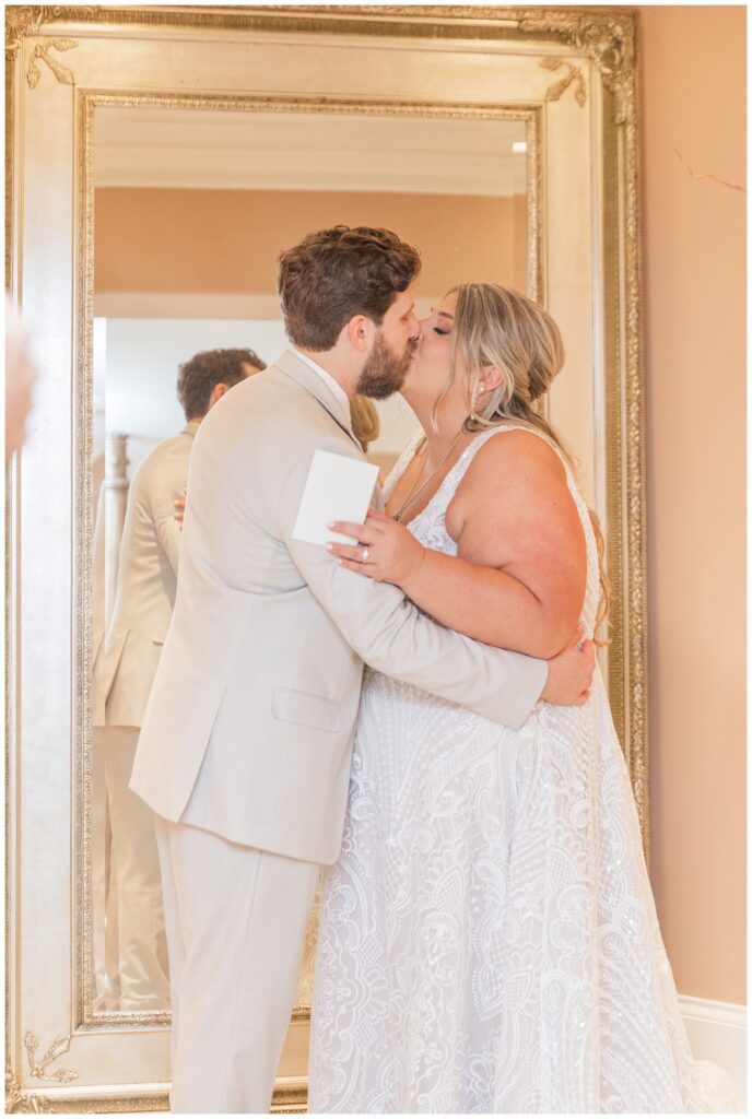 bride and groom kiss after reading their vows to each other before church ceremony