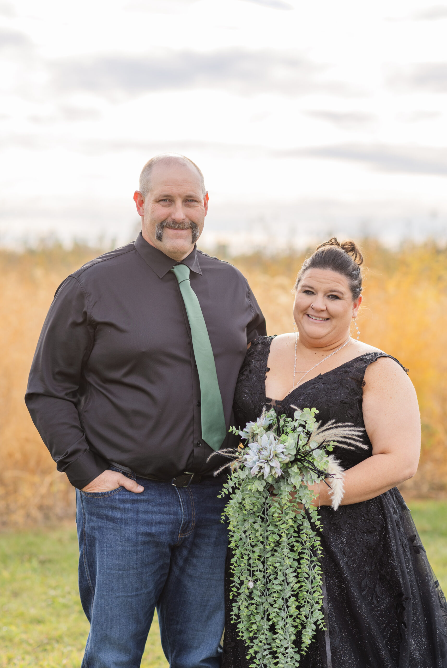 wedding couple posing in front of a field in Bucyrus, Ohio