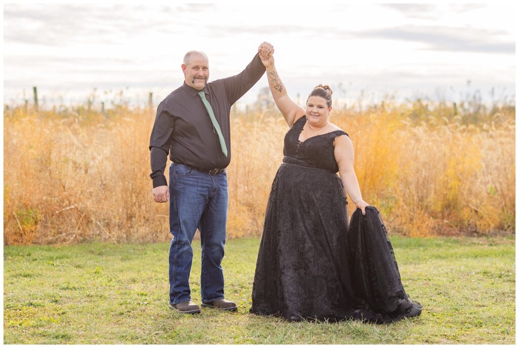 groom twirling the bride outside in front of tall grass at Pickwick Place