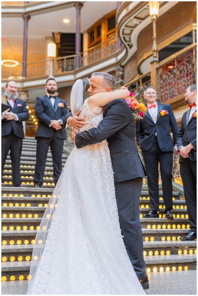 bride hugging her dad on the stairs before the ceremony starts