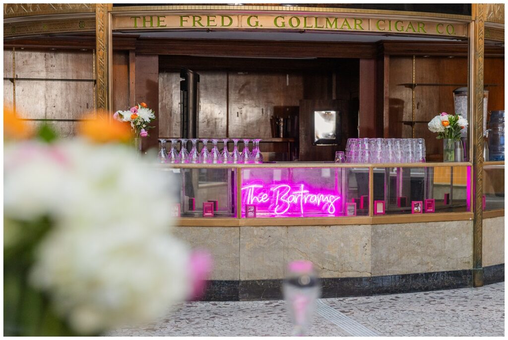 bar decorated with purple neon sign with the wedding couple's last name