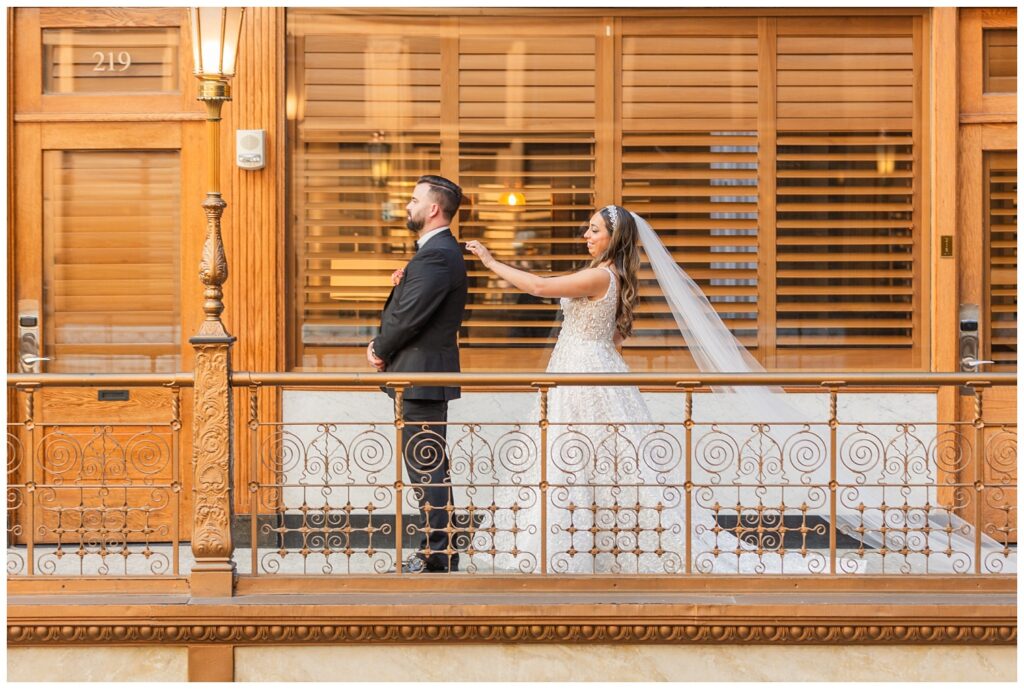 bride touching the groom's shoulder during their first look in Cleveland, Ohio