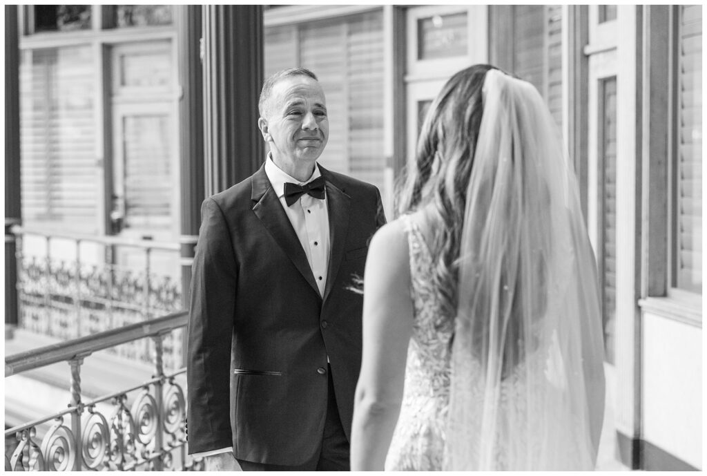 bride and her dad having a first look on the balcony of the Arcade Cleveland