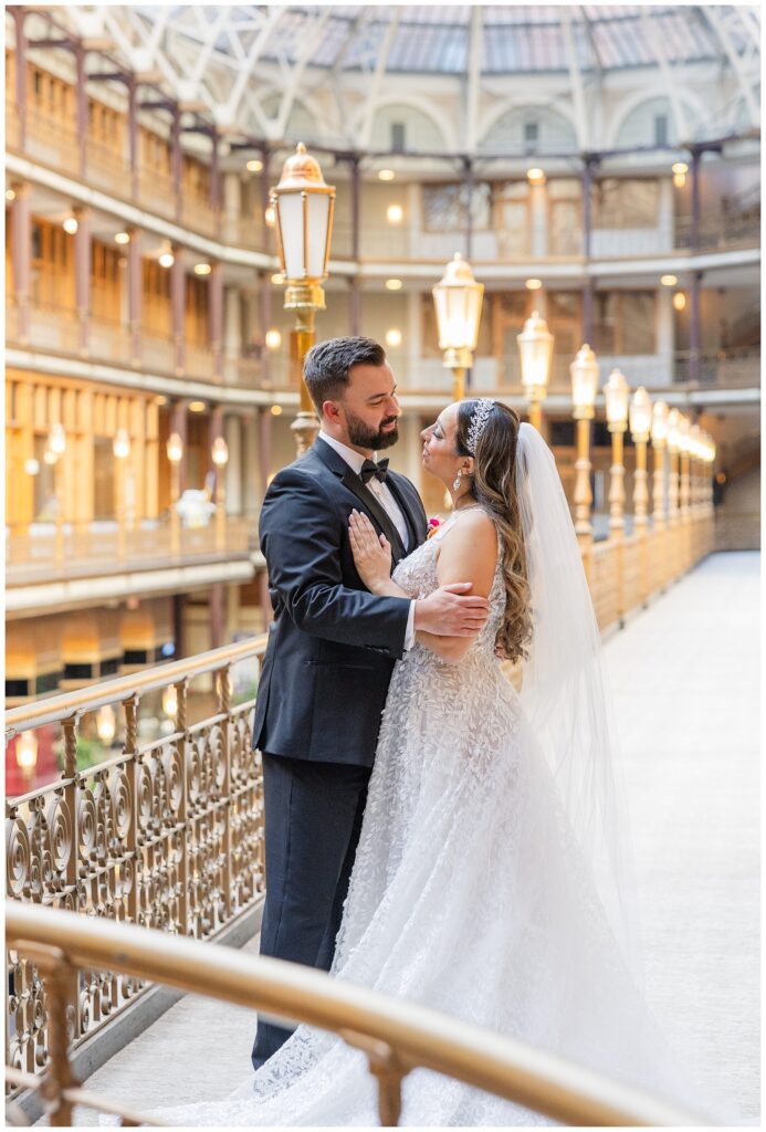 bride posing with the groom for wedding portraits before the ceremony