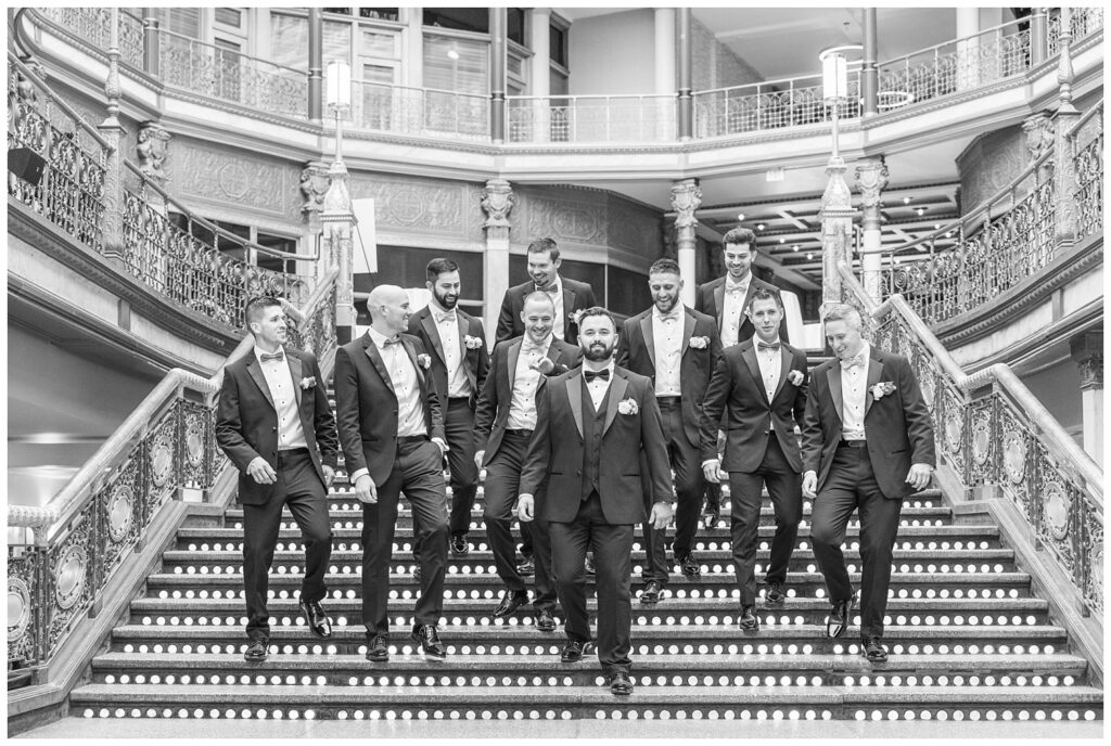 groomsmen walking together as a group down the stairs at the Arcade Cleveland