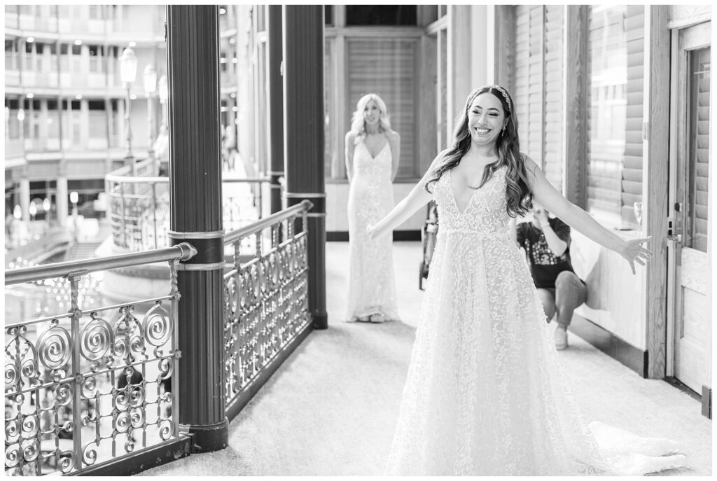 bride having a first look with her bridesmaids on the balcony at the Arcade venue